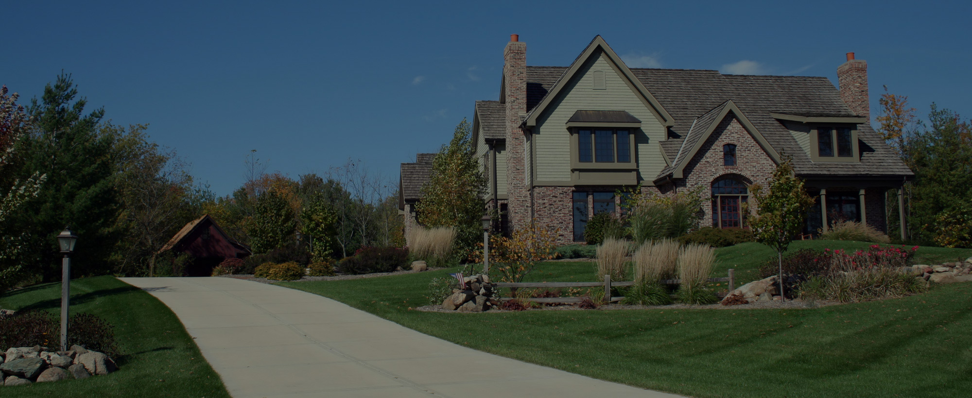 Luxurious executive home with driveway and blue sky